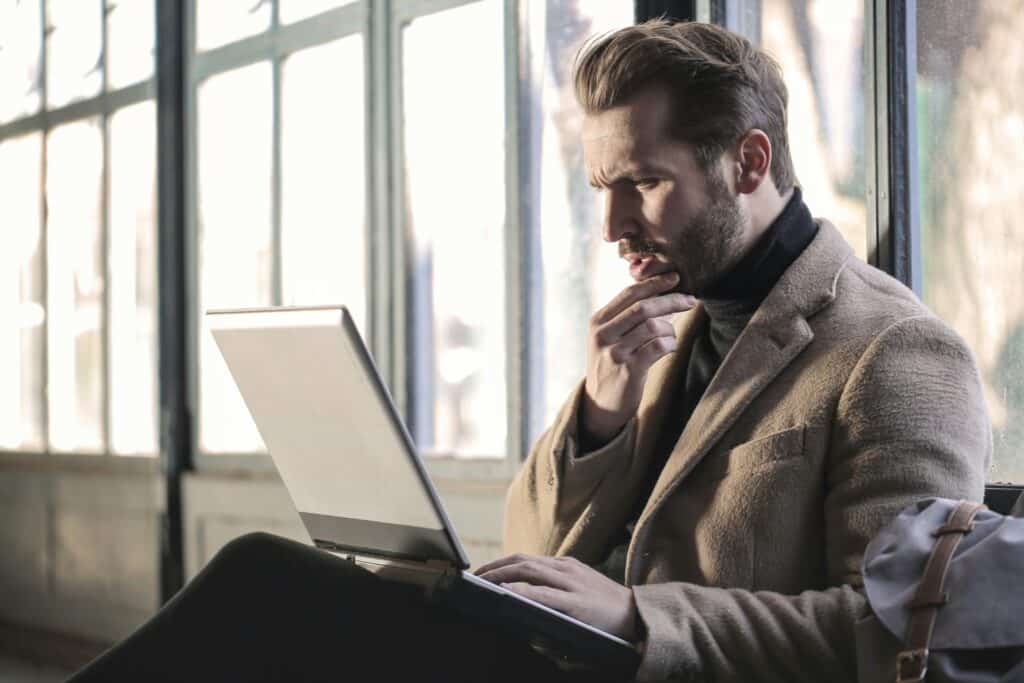 Man looking at data-driven insights on laptop