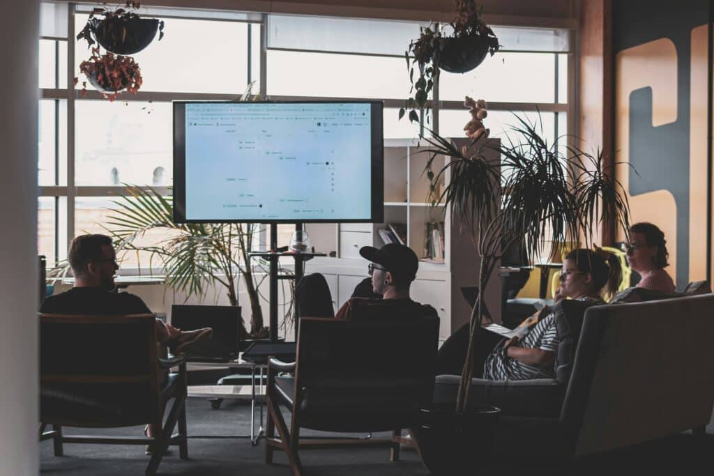 People in a meeting room looking at market intelligence on a screen