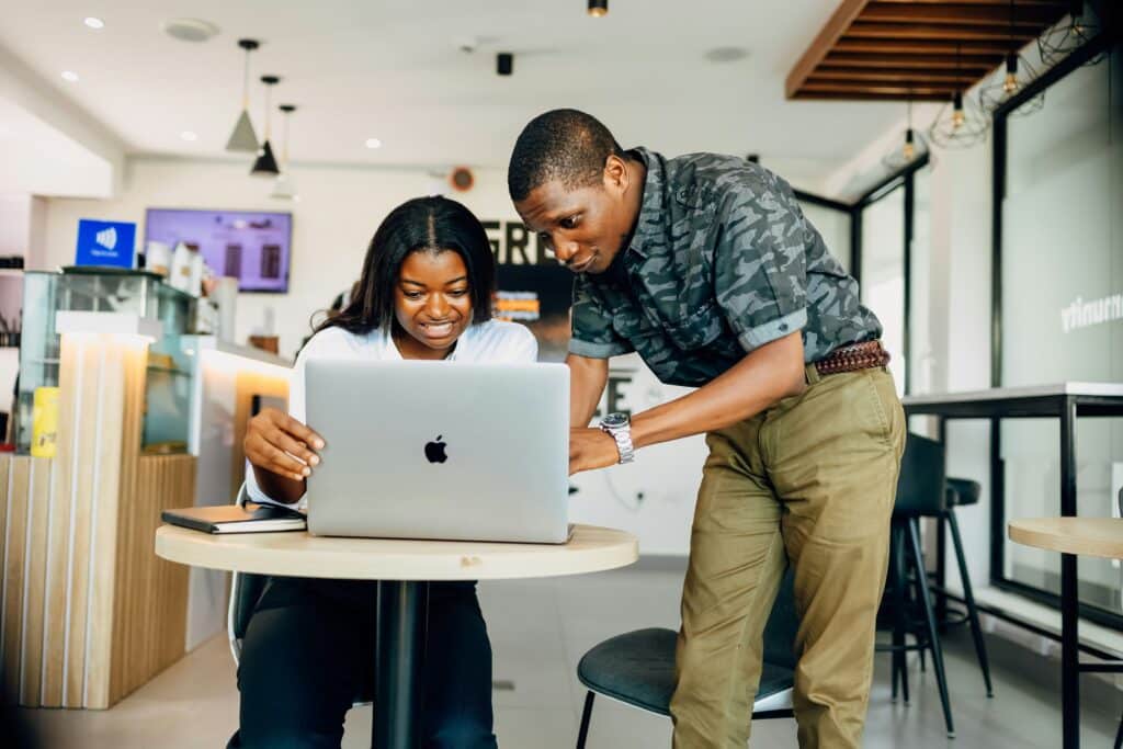 Two people look at a laptop and explore unstructured data
