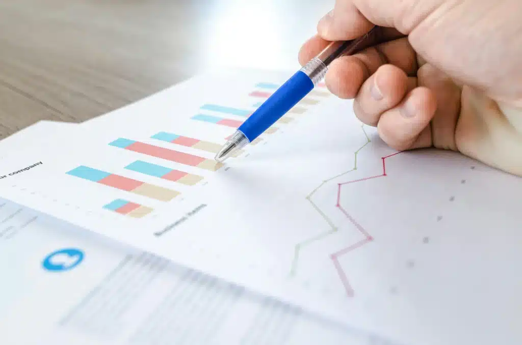 a hand holding a pen looking at a graph symbolizing a person analyzing data against data decay