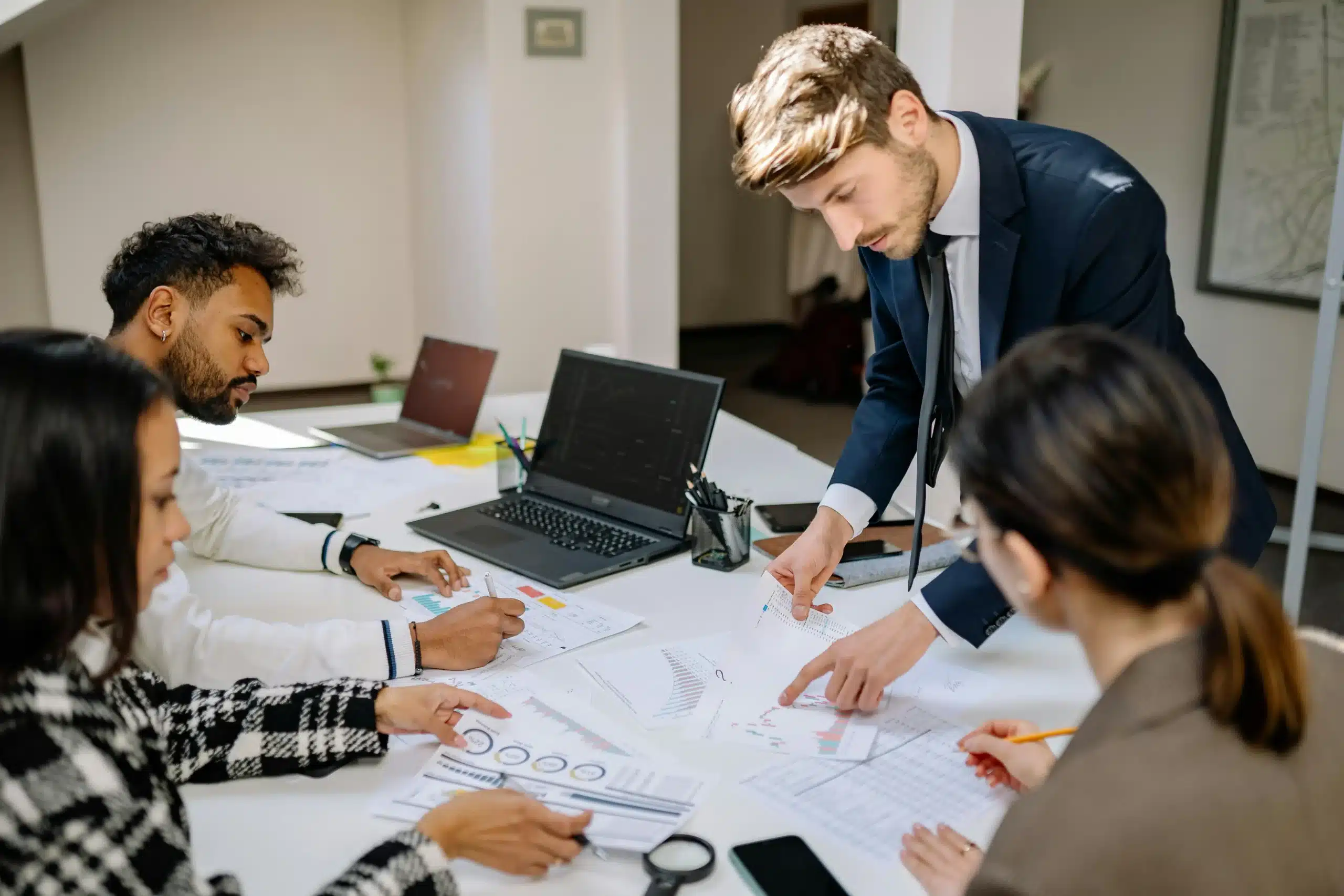 a team of people at a desk looking at statistics in an attempt to mitigate the use of outdated data