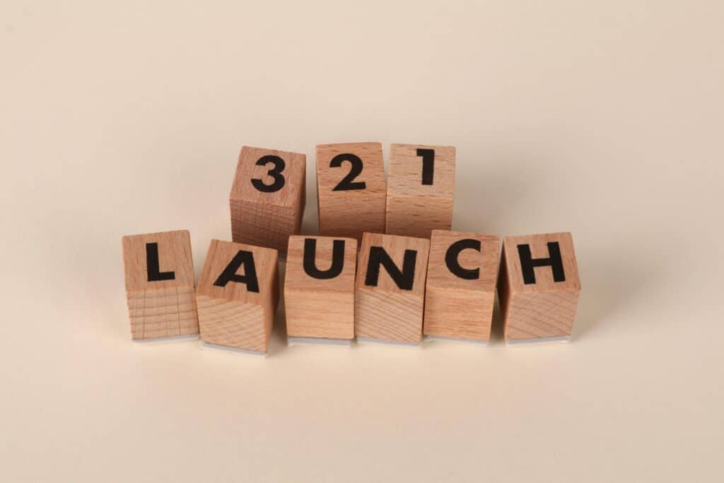 Numebers and letters etched on pieces of wood representing a product launch